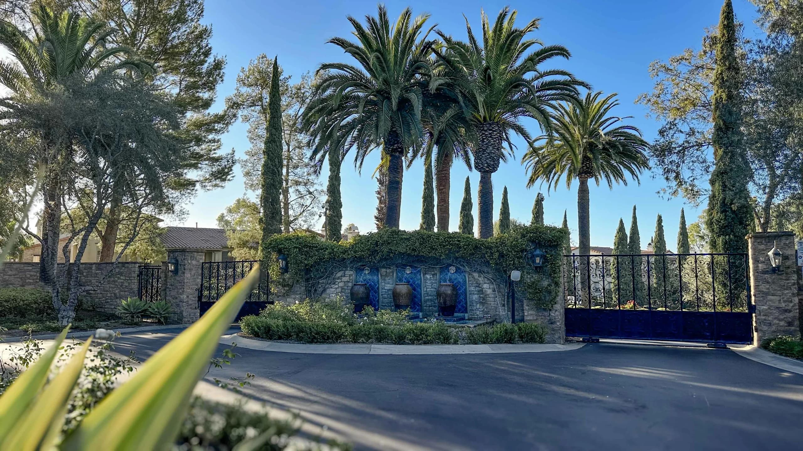 Landscaped gated entrance to Ziani in Newport Coast